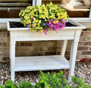 lot 197 image: White Elevated Outdoor Planter with Blooming Flowers