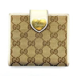 lot 46 image: Gucci GG Canvas Heart Tab Bifold Wallet in Beige and Ivory Leather Pre-Owned Retail $425