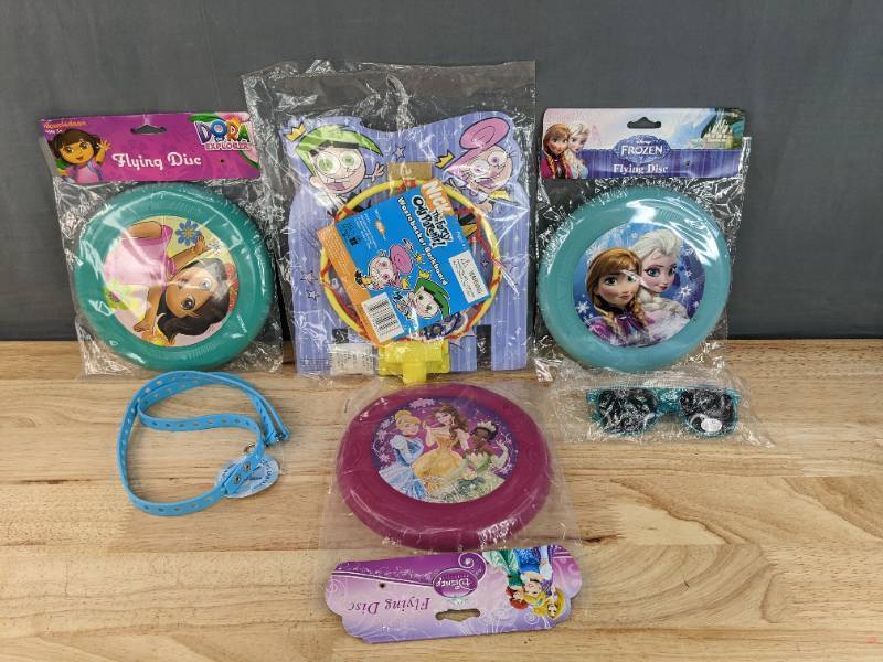 lot 83F image: New Disney and Nickelodeon Kids Toys Dora the Explorer, Disney Princesses, and Frozen Flying Discs, Kid Sunglasses, The Fairly Odd Parents Waste Basket Backboard, and Blue Silicone Lanyard N