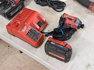 lot 214 image: Milwaukee 14-drive 18V Impact Driver with M18 Battery, Charger