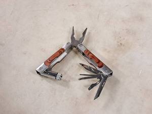 lot 230 image: Multi-Use Hand Tool - Blades, Pliers, Saw, Opener, Drivers