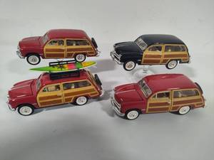lot 90 image: Four Small Scale 1949 Ford Woody Wagons