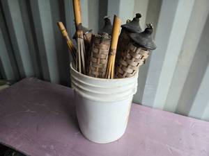 lot 52 image: Bucket of Used Tiki Torches