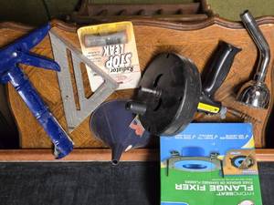 lot 191 image: Assortment of Plumbing and Automotive Tools includes a HydroSeat flange fixer, a plumbing snake, a funnel, a caulking gun, a speed square, and a radiator stop leak produc
