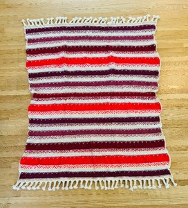 lot 58 image: Vintage Handmade Crochet Afghan Blanket in Hues of Reds with Braided Fringe