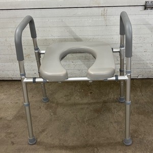 lot 9 image: Pelegon RTS1 Toilet Seat Commode Chair with Assist Handles offers sturdy support and comfort. Designed for easy use and safety, its perfect for home care or medical facilities. Great condition, reliable and practical for daily needs.