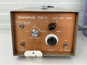lot 55 image: Olympus CLK-3 Compact Cold Light Source with 15W Halogen Lamp  Portable, Bright, and Easy to Use. Offers Balanced Illumination at 3250K for Surgical Sites. Connects Instantly to Olympus OES Fiberscopes. Great Condition, Up to 50 Hours Lamp Life.