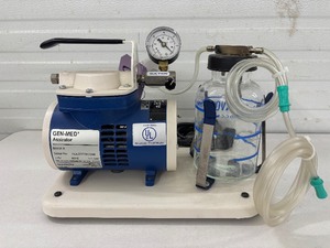 lot 75 image: Gen-Med Aspirator Model A Suction Device  built tough with a durable glass collection bottle. Clears airways fast, supports surgeries, wound care, and tracheostomy management. Reliable, efficient suction for safer, smoother patient care every time