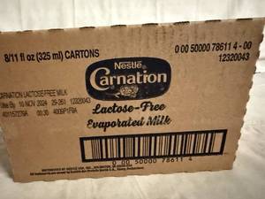 lot 128 image: 8 Cans of Carnation Evaporated Milk
