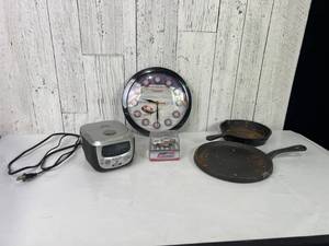 lot 552 image: Items Including Iron Skillets, NASCAR Collectible, Clock, and Radio