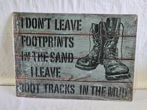 lot 142 image: Decorative Wall Sign with Boots and Quote I dont leave footprints in the sand, I leave boot tracks in the mud.
