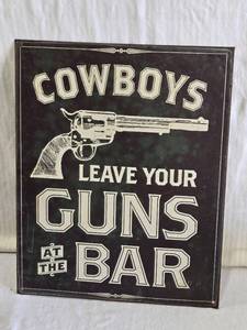 lot 144 image: Metal Sign with Cowboy Gun Theme COWBOYS LEAVE YOUR GUNS AT THE BAR
