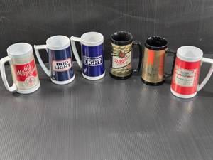 lot 161 image: Vintage Beer Stein Mugs with Various Brand Logos Old Milwaukee, Bud Light, Budweiser Light, Miller High Life, Michelob, and Budweiser