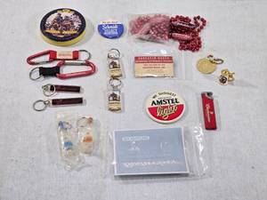 lot 202 image: Lot of Beer and Alcohol Memorabilia Items including brands like Budweiser, Schmidt, Amstel Light, and Captain Morgan