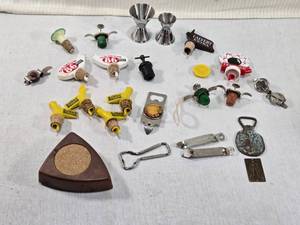 lot 204 image: Barware and Bottle Openers featuring brands like Old Taylor, Sunny Brook, Calvert Extra, and Ten High. Also included is a 1969 Royal London Roller Coaster wind up canbottle carrier