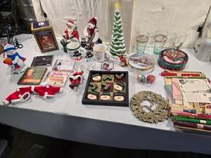 lot 282 image: Huge Lot of Christmas Decor - Coca-Cola glasses, snowman figurines (including Gonzaga Snowman), Santa Claus decorations, CDs, a ceramic Christmas tree