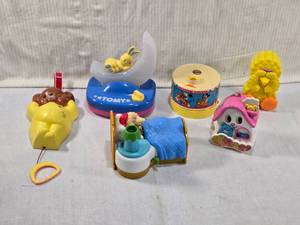 lot 285 image: Vintage Musical Toys and Figurines including a Fisher Price music box in the shape of a teddy bear, a Disney-themed Dreamtime Carousel, and a Tomy musical toy