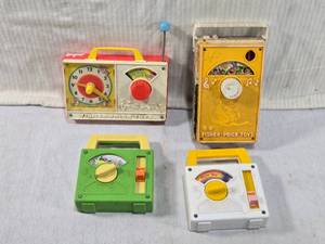 lot 288 image: Vintage Fisher-Price Musical Toys Hickory Dickory Dock, Toyland, and Over The Rainbow.