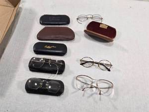 lot 308 image: Vintage Eyeglasses with Cases marked with names like Hollmans, Archer of Miami, and Dr. C.C. Warren