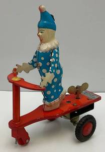 lot 7 image: Vintage Tin Litho Wind-Up Clown On Scooter (Works) 4 12