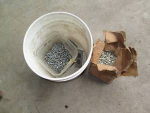 lot 114 image: Bucket with roofing nails and other...