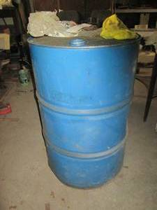 lot 262 image: Empty metal 55-gallon oil drum...