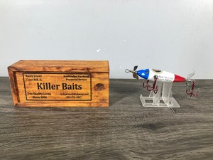 lot 229 image: Killer Baits fishing lure made by Rusty Jessee, patterned after the Heddon Style 100 series, featuring glass eyes and a patriotic Stars & Stripes Eagle design with TRUMP written on it