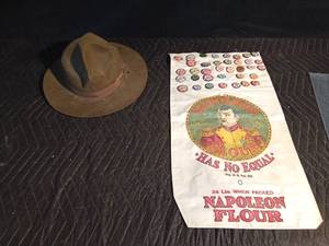 lot 115 image: ranger hat and Napoleon Flour sack with MachinistMechanic district pins