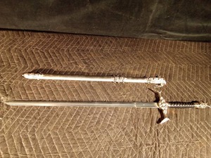 lot 80 image: Sword with metal sheath with skulls on it
