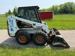 lot 7 image: Used Bobcat Skid Steer Loader with Bucket Attachment