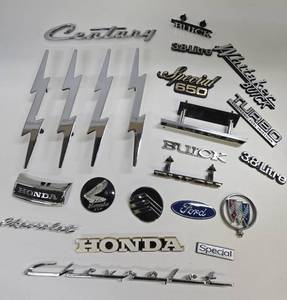 lot 365 image: Group of Metal Auto Dealer & Car Emblems w4 Unused Chrome Lightning Bolt Handles