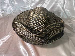 lot 97 image: Handwoven Straw Hat with Intricate Black and Tan Pattern