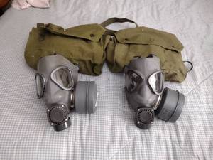 lot 112 image: 2 Vintage Finnish military gas masks, Suod 61T KRH ASC 12x30, with green canvas carrying bag.
