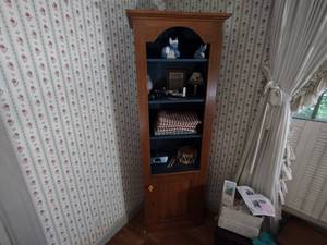 lot 109 image: Wood Tombstone Curio Cabinet  bookshelf with 4 shelves and lower hidden storage. H 79 x W 14 x L 24