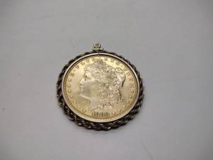 lot 260 image: Possibly raw gold colored 1880 silver dollar 0 mint