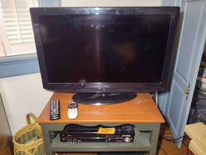 lot 218 image: Insignia TV and Panasonic DVD player with remotes.