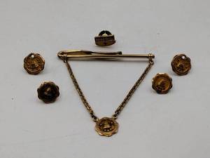 lot 65 image: 10k gold tie tacks and tie clip reading Northwestern Bell one reads Horace Mann, 19g