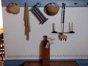 lot 294 image: Baskets, candles, candle snuffers, long matches in a matchbox holder, primitive 2-candle sconce,