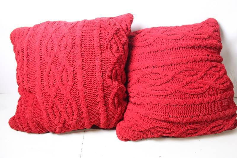 lot 196 image: Pair of Red Knitted Throw Cushions with Intricate Patterns