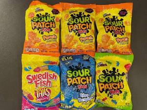 lot 90 image: Assorted Sour Patch Kids Candies including Peach, Blue Raspberry, and Swedish Fish