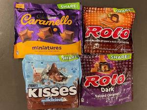 lot 91 image: Assorted Candy Share Packs - Hersheys Kisses, Cadbury Caramello, and Rolo