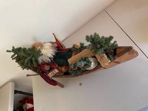 lot 309 image: Rustic Santa Claus with Snowshoes in Wooden Canoe Decoration