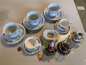 lot 858 image: Portmeirion Handcrafted Teacup Set with Assorted Porcelain Figurines