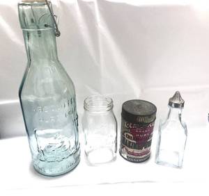 lot 92 image: Large Vintage The Milk Protector Milk Botte, Hospital Bottle, Montgomery Wards Banking Powder Tin and Cruet