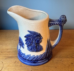 lot 20 image: Vintage 9.5 Blue and White Ceramic Pitcher with Native American Motif