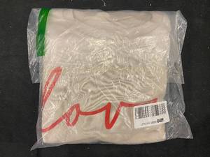 lot 94 image: 196 - Unopened White Sweater with Red Love Script - Size M