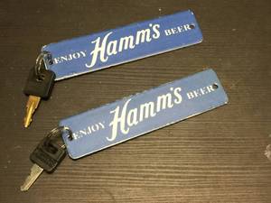 lot 211 image: Vintage Hamms - Porcelain Crat TagRestroom Keys