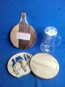 lot 52 image: Cheese Cutting Board with Tools, A Wood Cutting Board, and A Mainstays 3-Quart Plastic Water Pitcher with Lid and Removeable Rod for Ice Core, Clear