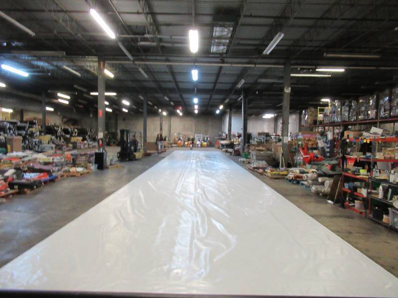 lot 117 image: NEW Vinyl Tarp - 16.33 x 100  Black  White Vinyl tarp - 9 oz. Lightweight Duty