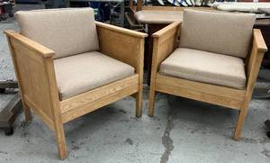 lot 23 image: Set of 2 Solid Wood Armchairs  Clean, Classic & Comfy Timeless oak-toned frames with neutral padded seats and backs. Great for office, lounge, or waiting areas. Sturdy and stylish with a natural finish that fits any space.